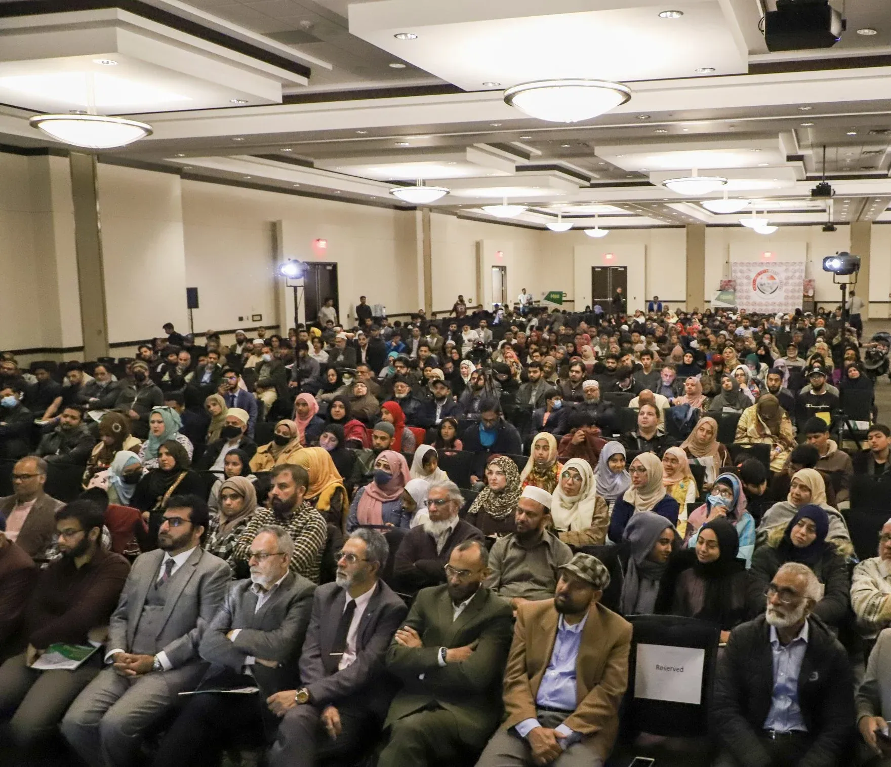 A full audience hall at an Al-Rahma conference